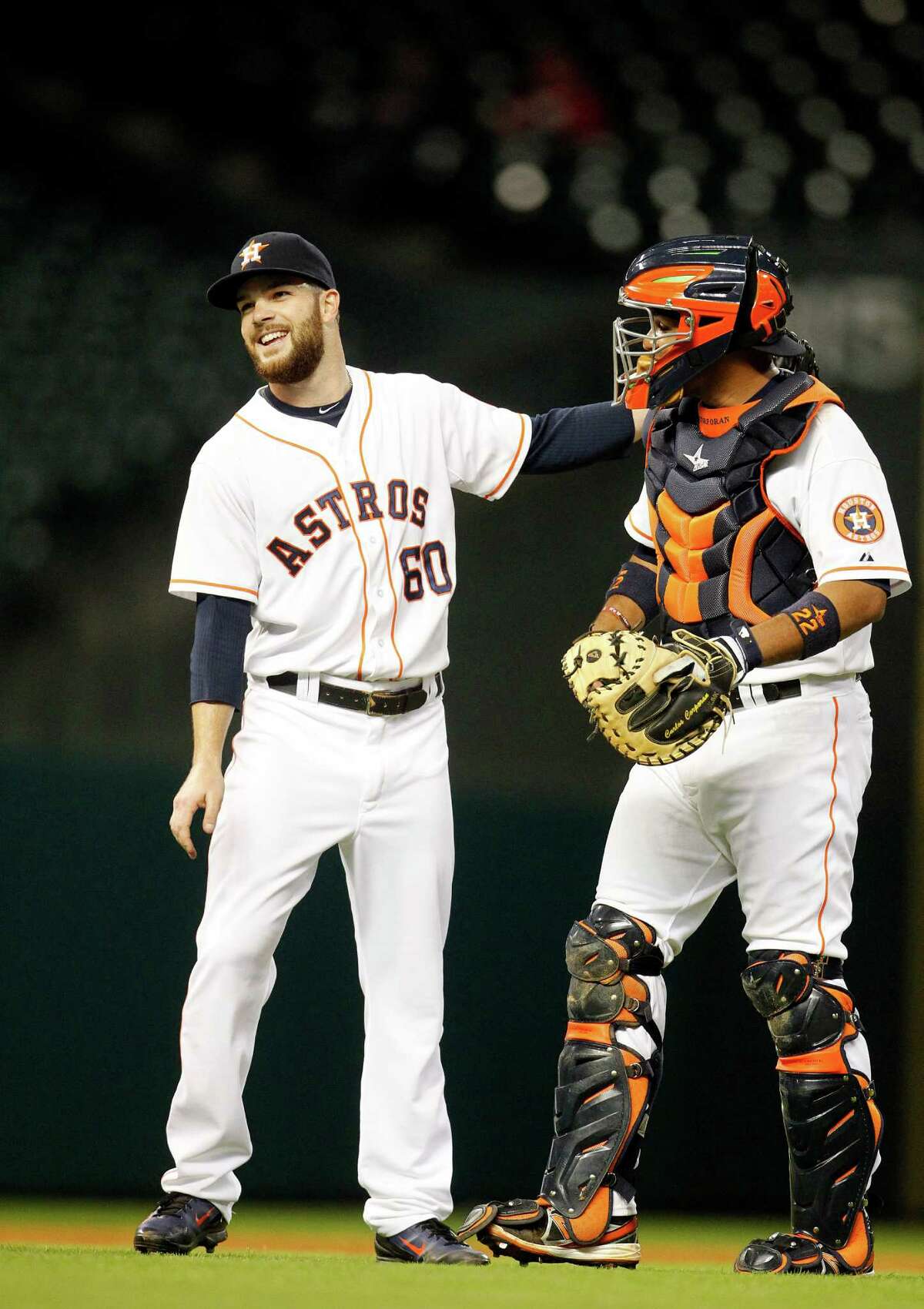 Dallas Keuchel, left, gets the last laugh and congratulations from catcher Carlos Corporan after lasting longer than any Astros pitcher had this season. Keuchel shut out the Rangers on seven hits Tuesday night for the team's first complete game.