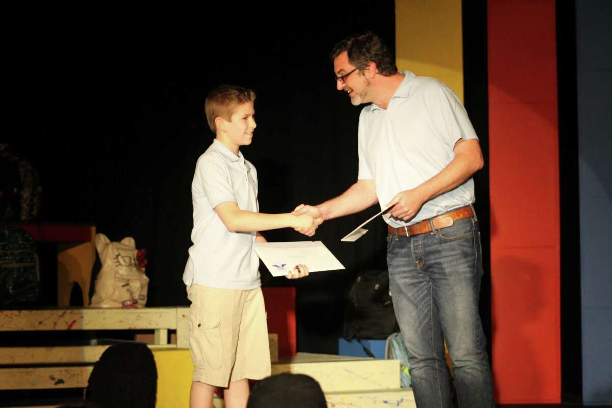 Chase Fontenot receives his Silver Level Presidential Volunteer Service Award from Gregory Magyar, executive artistic director at KVPAC, on May 10.