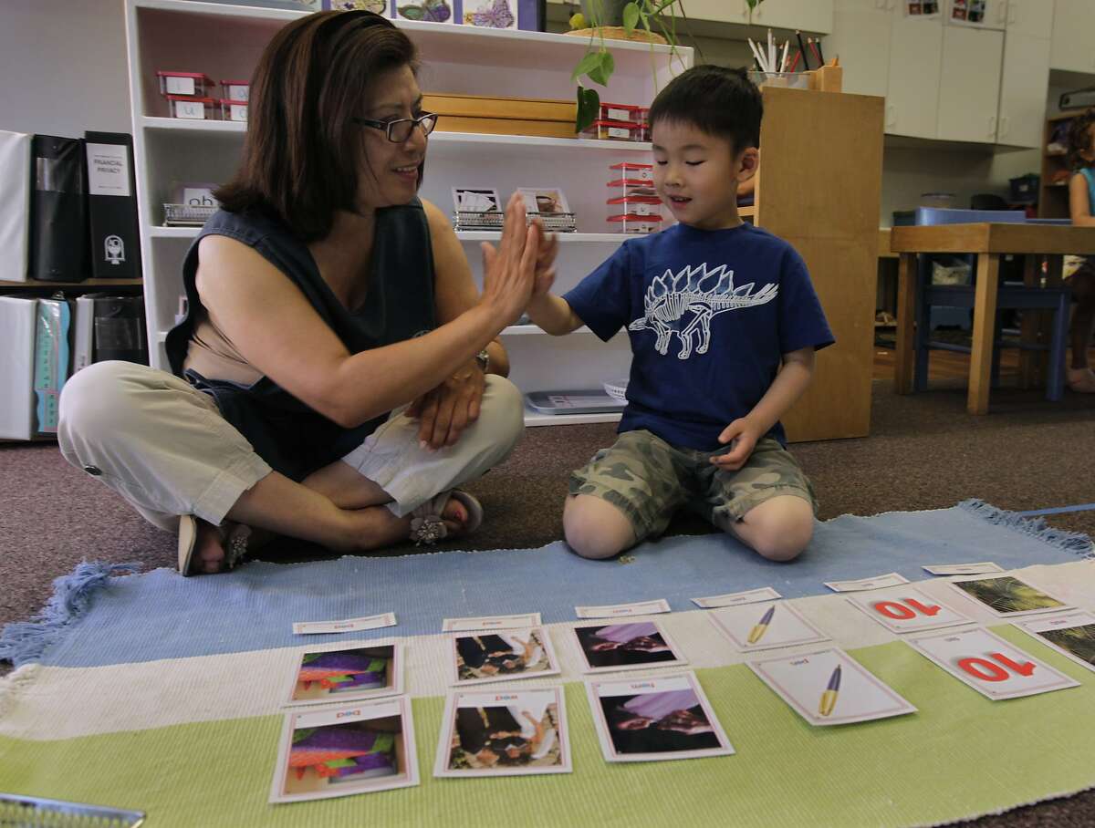 Teacher Sonia Castro high-fives Alfred Chen during a learning lesson at the Montessori School at Five Canyons in Castro Valley, Calif. on Wednesday, May 14, 2014. A UC Berkeley study found that most preschools surveyed had some levels of hazardous particulates in air and dust samples taken from the 40 schools but the Montessori school, which was not among those in the study, takes great effort in using toxic-free and environmentally safe materials for the preschoolers.