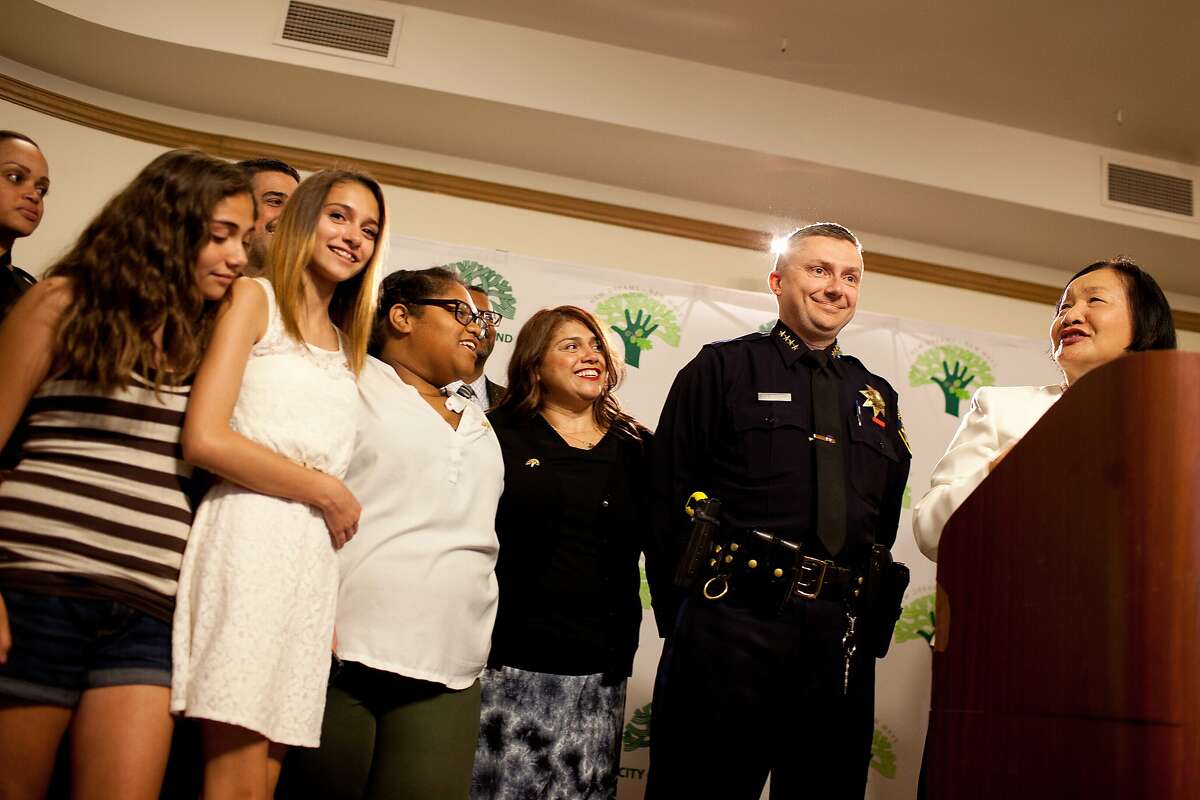 Mayor Jean Quan, right, announces the appointment of interim chief Sean Whent, a 17-year veteran of the force, to be the police chief as his family, left to right, Allison 12, Kamryn, 13, Angelique, 21, and wife Julie stand by his side at City Hall in Oakland, Calif. on Wednesday, May 14, 2014.