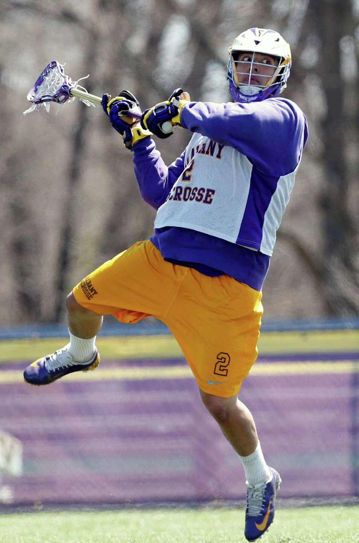 In this photo taken on Monday, April 28, 2014, University at Albany lacrosse player Miles Thompson (2) practices in Albany, N.Y. A trio of Native American players, Miles, younger brother Lyle, and cousin Ty, have transformed Albany into an offensive juggernaut in Division I men's lacrosse. (AP Photo/Mike Groll) ORG XMIT: NYMG203