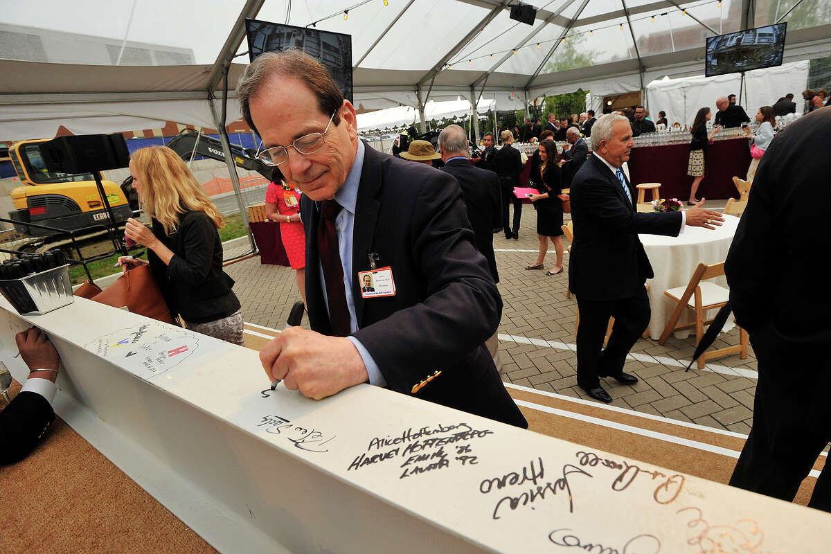 Dr. Steven Horowitz, chief cardiologist at Stamford Hospital, signs one of two steel girders during the topping off ceremony of the new wing of Stamford Hospital in Stamford, Conn., on Wednesday, May 14, 2014.