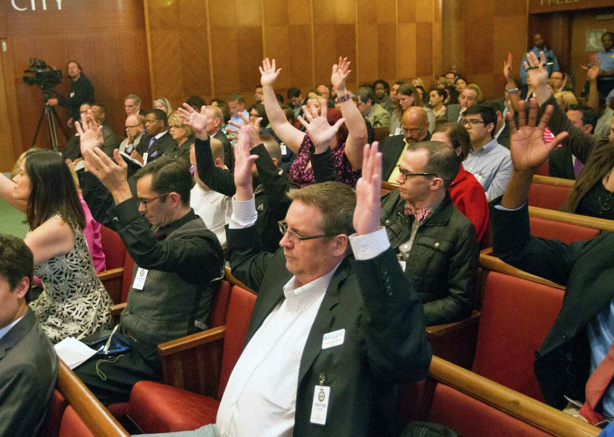 Backers react at City Hall on Wednesday. The law would consolidate bans on discrimination and boost protection for gay and transgender residents.