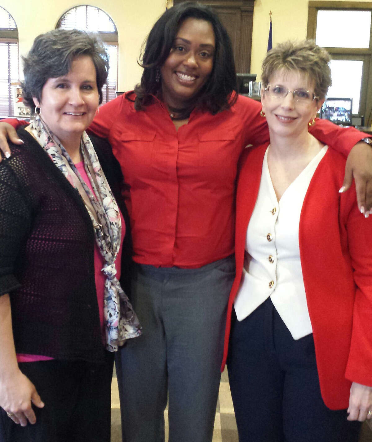 Allison Flood Lesh (center) with her attorneys Judith Wemmert (left) and Deanna Whitley, after they prevented the state of Texas from stopping the case.