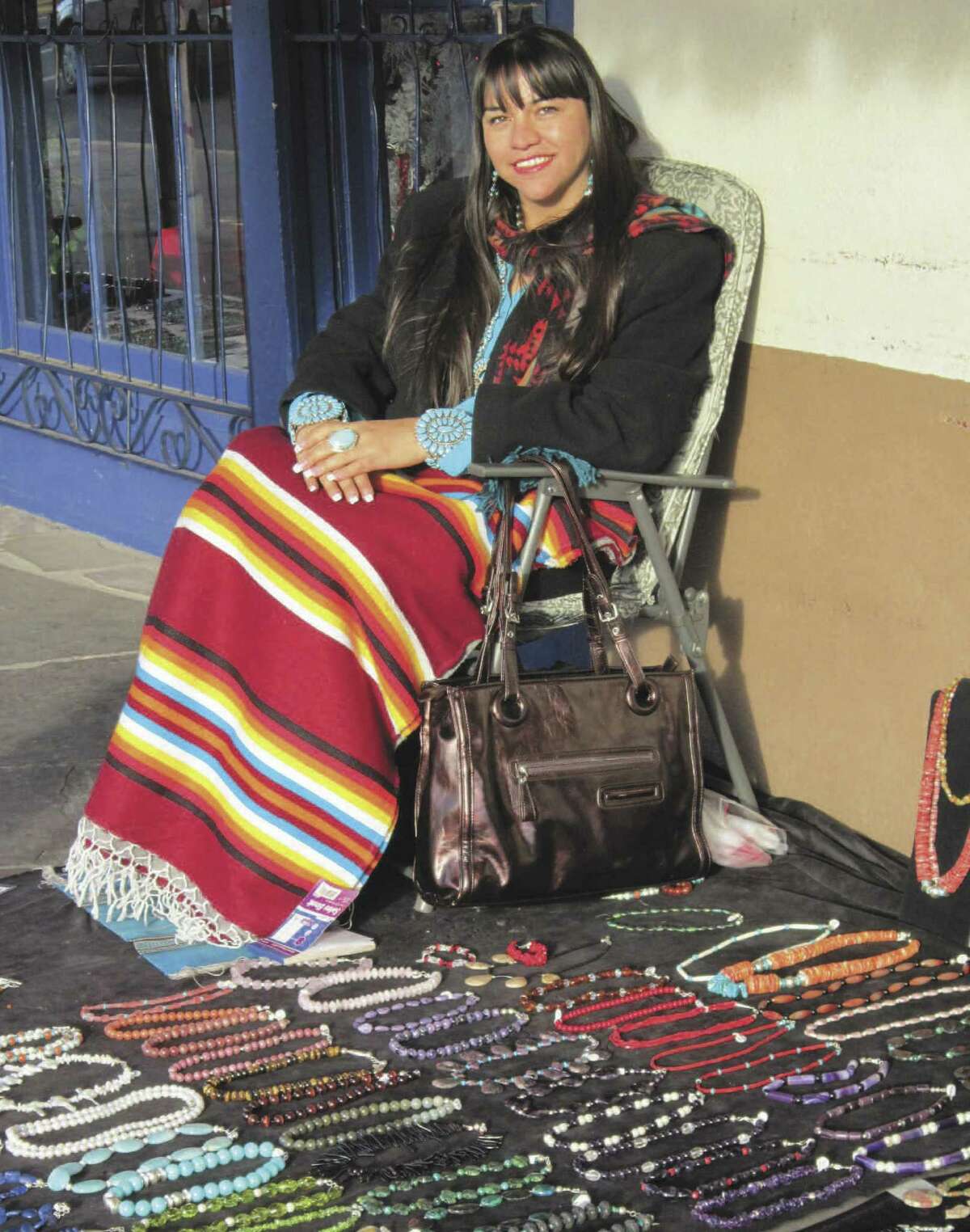 A vendor in Old Town Albuquerque displays her necklaces for sale.