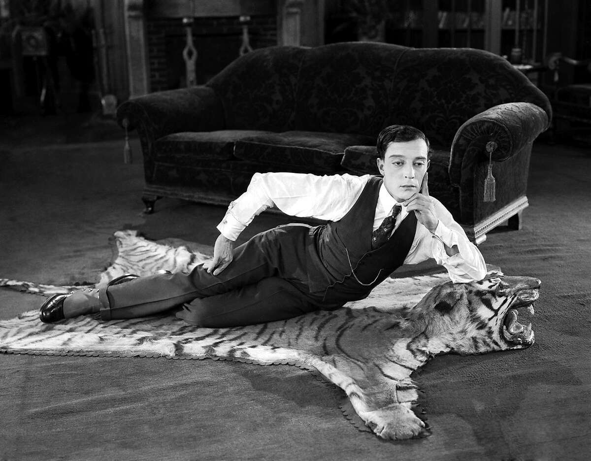 1924: American comedian Buster Keaton (1895-1966) lying on a tigerskin rug in his latest film 'The Navigator'.