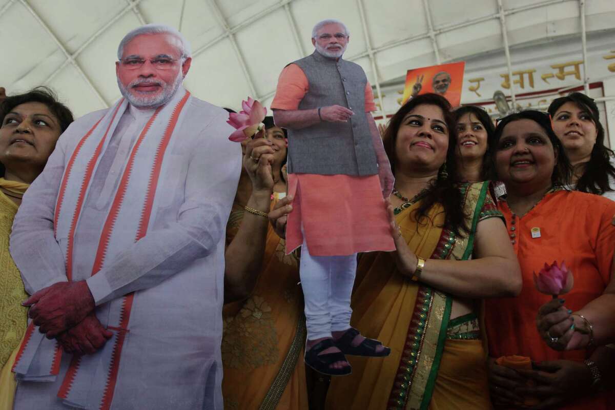 Supporters carry cut-out photographs of Narendra Modi, India's main opposition candidate for prime minister, as they gather Thursday at a Hindu temple to pray for his election victory in Ahmadabad, India.