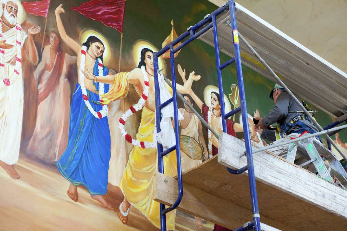 A mural receives finishing touches in preparation for the new Krishna center's grand opening and dedication this weekend.