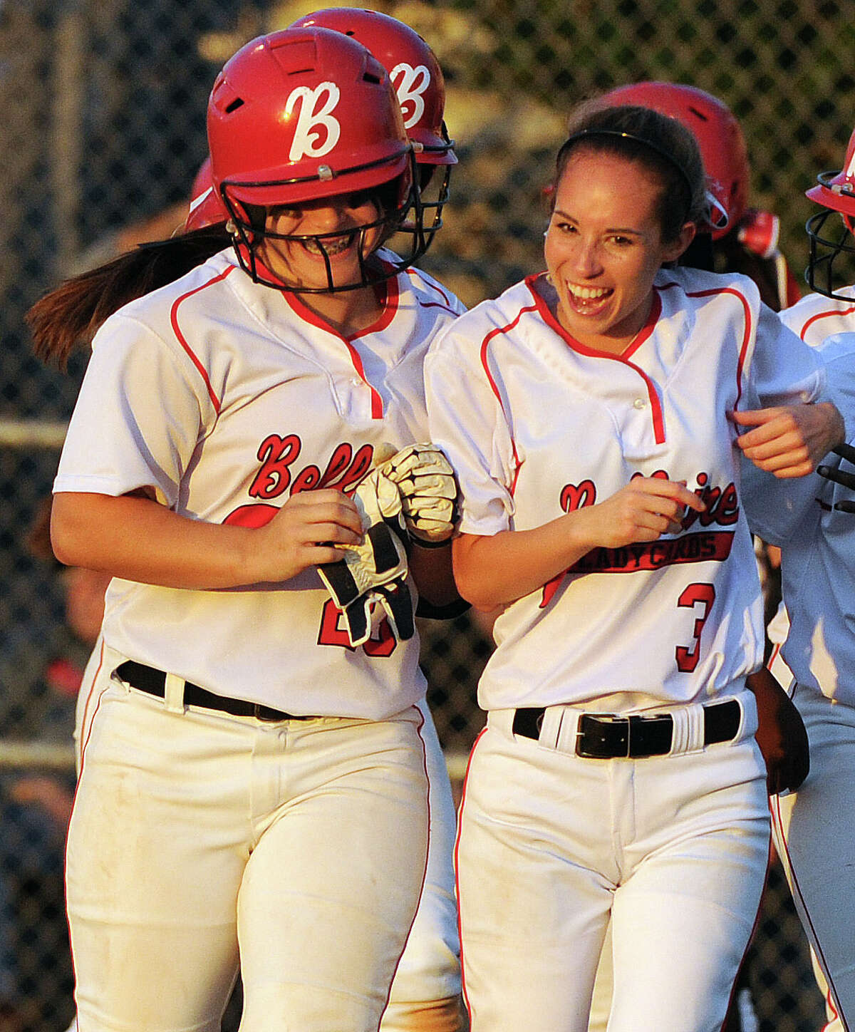 Haleigh Davis, left, celebrates her grand slam with Kaelyn Kringle in the third inning of Bellaire's 6-1 victory over Pearland on Thursday night.