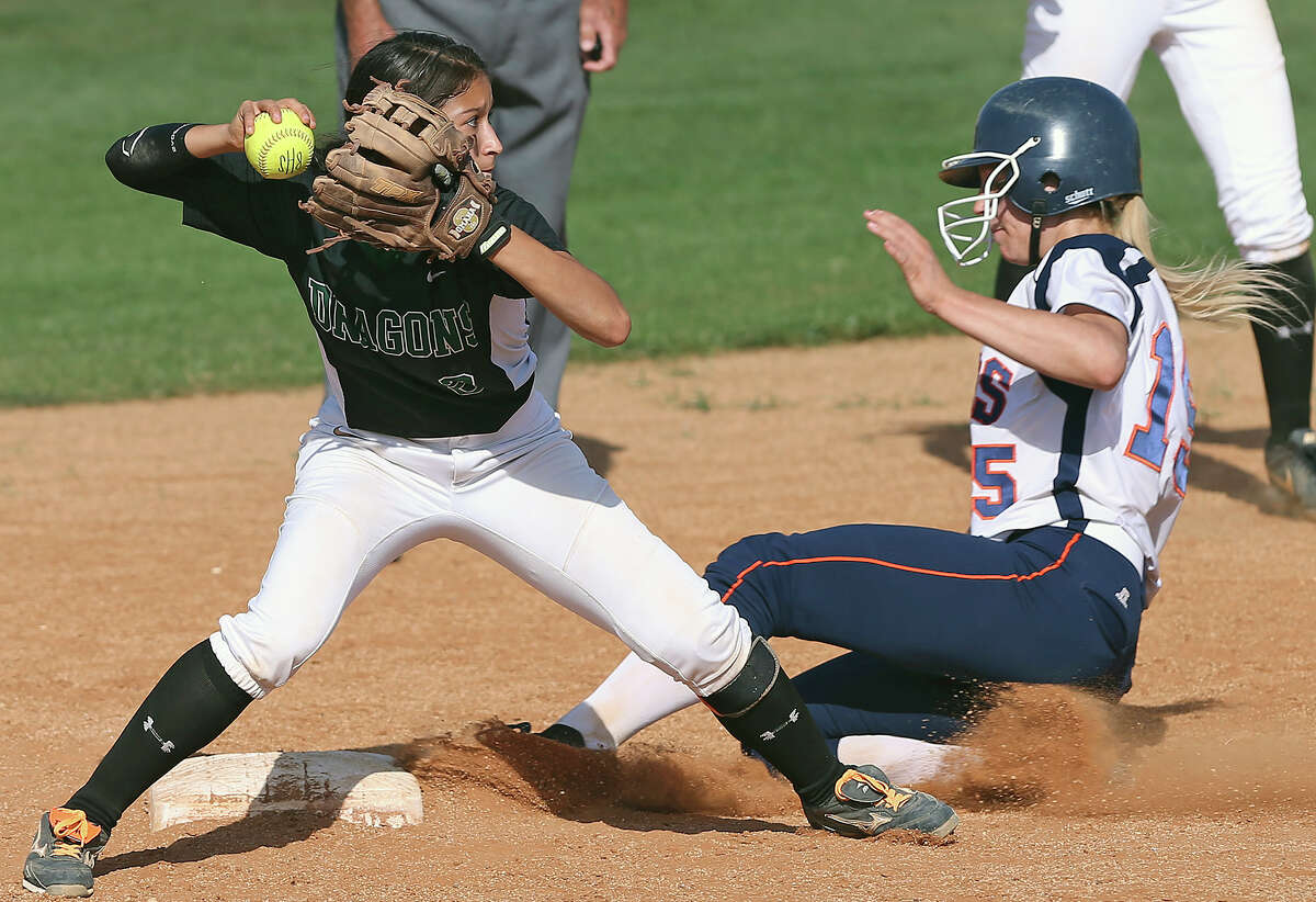 Dragons shortstop Kristal Salinas turns a double play by first getting Taylor Rosser out at second as Brandeis plays Southwest at Northside softball complex in a 5A first round playoff doubleheader on April 25, 2014.