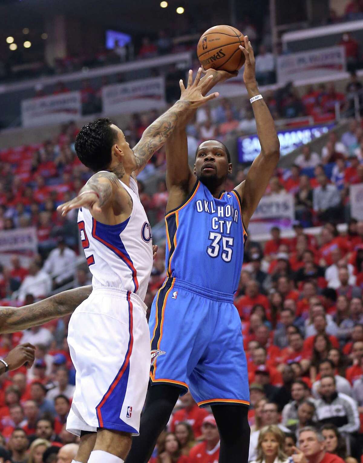 The Thunder's Kevin Durant, right, shoots over the Clippers' Matt Barnes for two of his 39 points in Thursday night's 104-98 series-clinching victory.