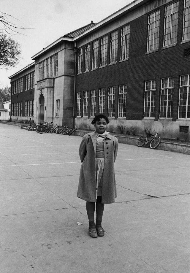 Linda Brown, a 9-year-old black girl refused admission to white elementary school in front of the segregated Monroe Elementary School which she attendsed. Photo: Carl Iwasaki, Time & Life Pictures/Getty Image / Carl Iwasaki