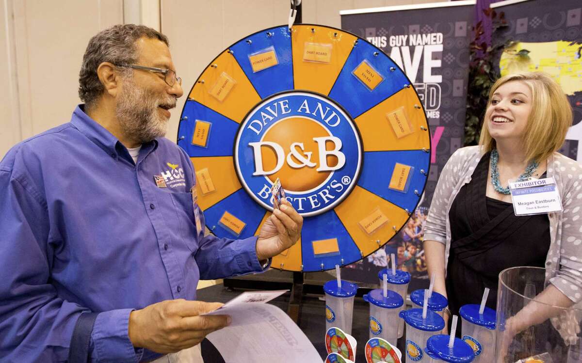Alan Corder of Houston Community College talks with Meagan Eastbum at the Dave and Buster's booth during the HR Houston conference. Companies that host parties were at the gathering to talk about their offerings.