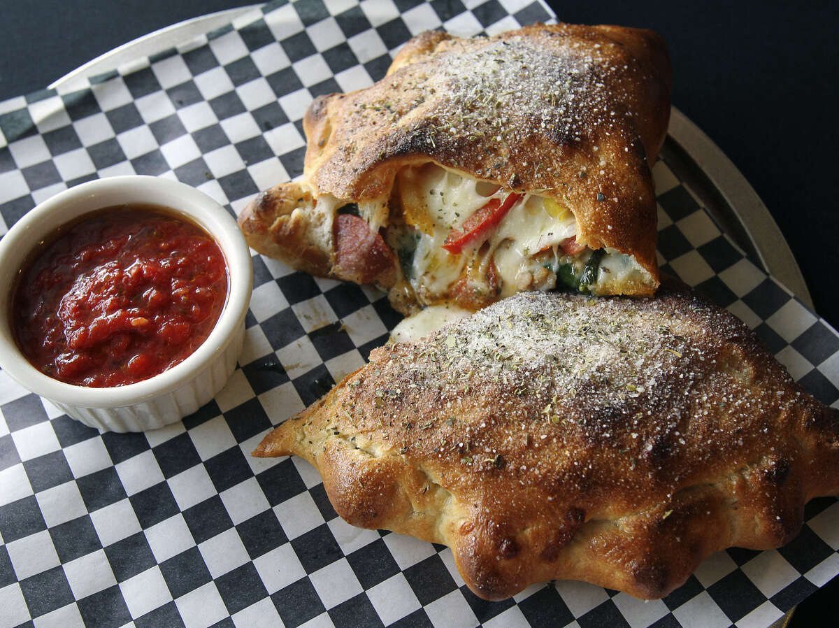 Tank's Pizza | Tank's is open for delivery and take-out during COVID-19. Their ooey, gooey calzones are perfect to share and remain a fan favorite.