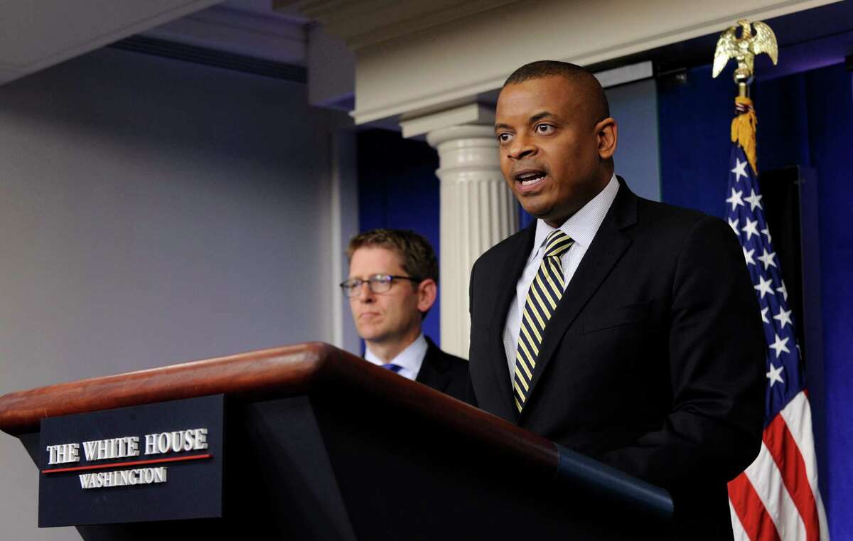 Transportation Secretary Anthony Foxx, right, accompanied by White House press secretary Jay Carney, speaks during the daily briefing at the White House in Washington, Monday, May 12, 2014. Foxx talked about transportation infrastructure in the United States including the federal Highway Trust Fund which is expected run dry by late August. Without congressional action, transportation aid to states will be delayed and workers will be laid off at construction sites nationwide, Foxx said. (AP Photo)