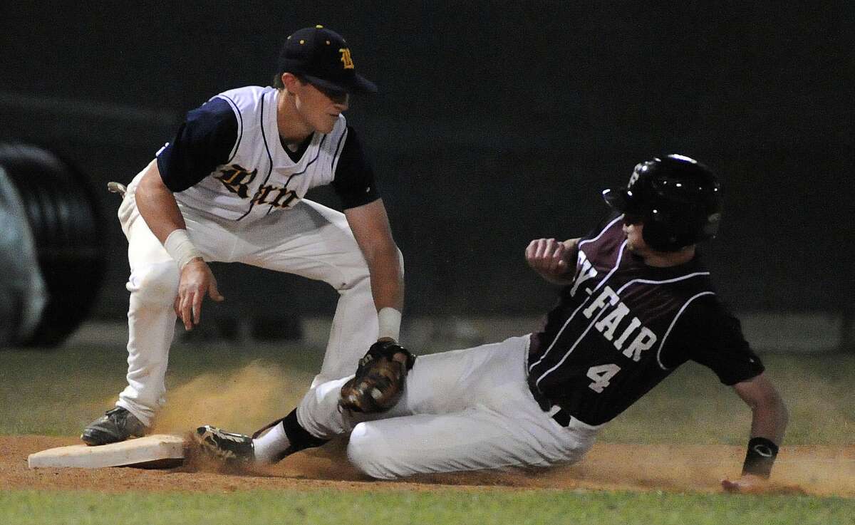 Cy-Fair's Clayton Kopecky, right, steals third base past Cy Ranch's Masen Hibbeler during the ninth inning of Friday's playoff game at Cy Woods High School.