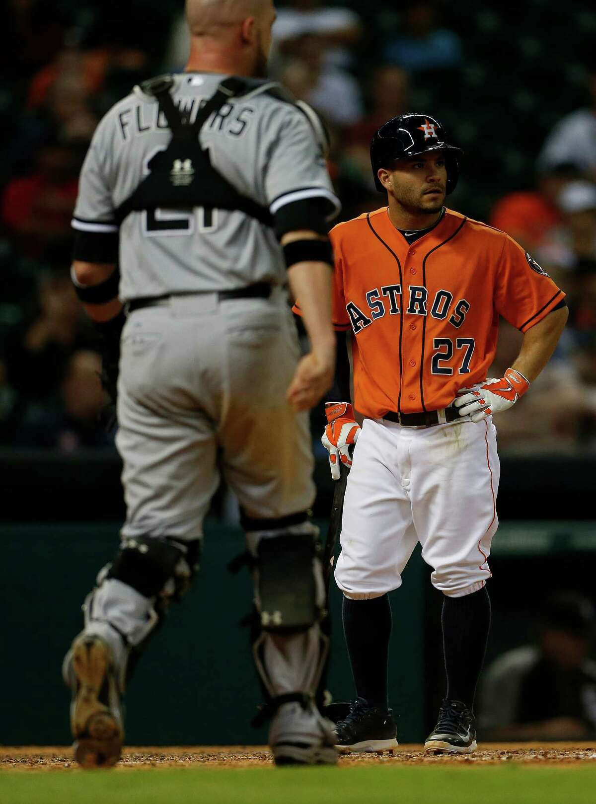 Jose Altuve, right, doesn't like what he sees after popping up to Chicago's Tyler Flowers.