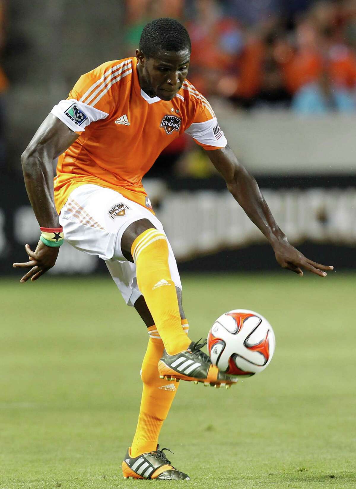 Houston Dynamo defender Kofi Sarkodie (8) traps the ball again as the Los Angeles Galaxy in the first half on May 17, 2014 at BBVA Compass Stadium in Houston, Texas.