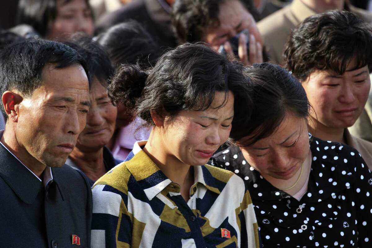 In this Saturday, May 17, 2014 photo, families of victims of an accident at an apartment construction site in Pyongyang, North Korea grieve during a gathering in the capital where senior officials apologized and took responsibility. The word of the collapse in the secretive nation's capital was reported Sunday morning by the North's official Korean Central News Agency, which gave no death toll but said that the accident was "serious" and upset North Korea's leader, Kim Jong Un. (AP Photo/Jon Chol Jin)