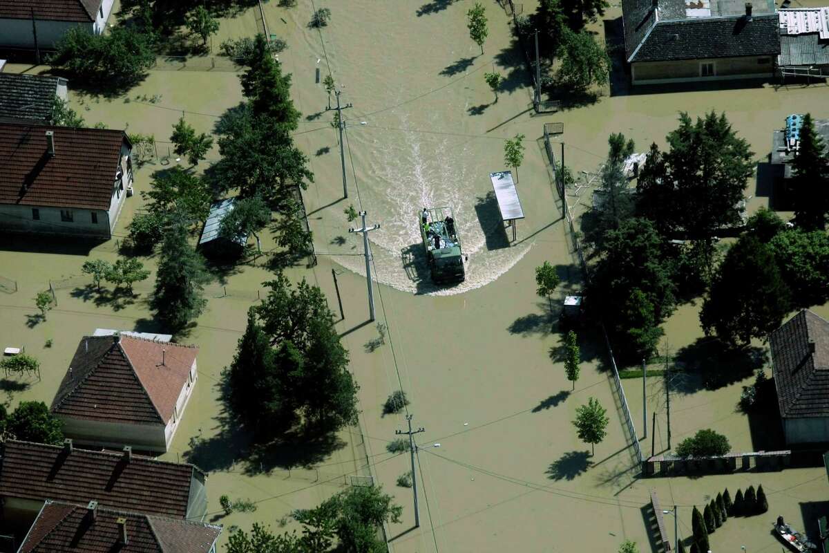 A flooded area is seen in Obrenovac, some 30 kilometers (18 miles) southwest of Belgrade, Serbia, Monday, May 19, 2014. Belgrade braced for a river surge Monday that threatened to inundate Serbia's main power plant and cause major power cuts in the crisis-stricken country as the Balkans struggle with the consequences of the worst flooding in southeastern Europe in more than a century. At least 35 people have died in Serbia and Bosnia in the five days of flooding caused by unprecedented torrential rain, laying waste to entire towns and villages and sending tens of thousands of people out of their homes, authorities said. (AP Photo)