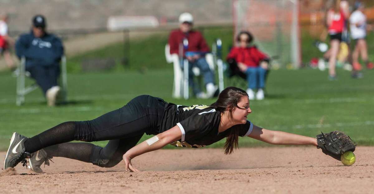 Trumbull high school shortstop Megan Thaler dives for an infield ground ball during a softball game against Greenwich high school played at Greenwich high school, Greenwich, CT on Monday, May, 19th, 2014.