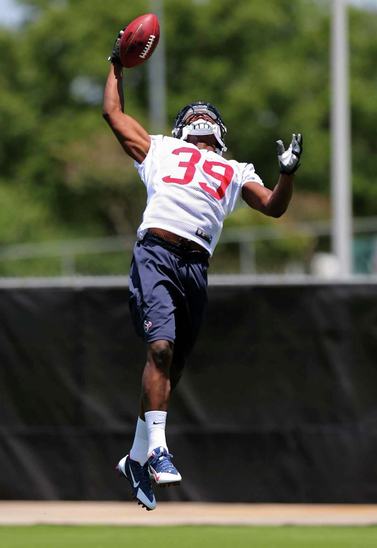 Safety Lonnie Ballentine provides a glimpse of his leaping abilities Saturday during the Texans' rookie minicamp at the team's practice facility.