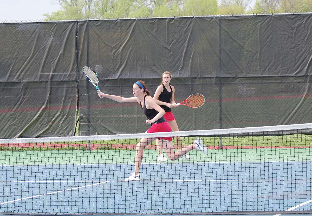 New Canaan's Emily Brand and Sarah Lovejoy compete in the No. 1 doubles match of Monday's home girls tennis match against Darien.