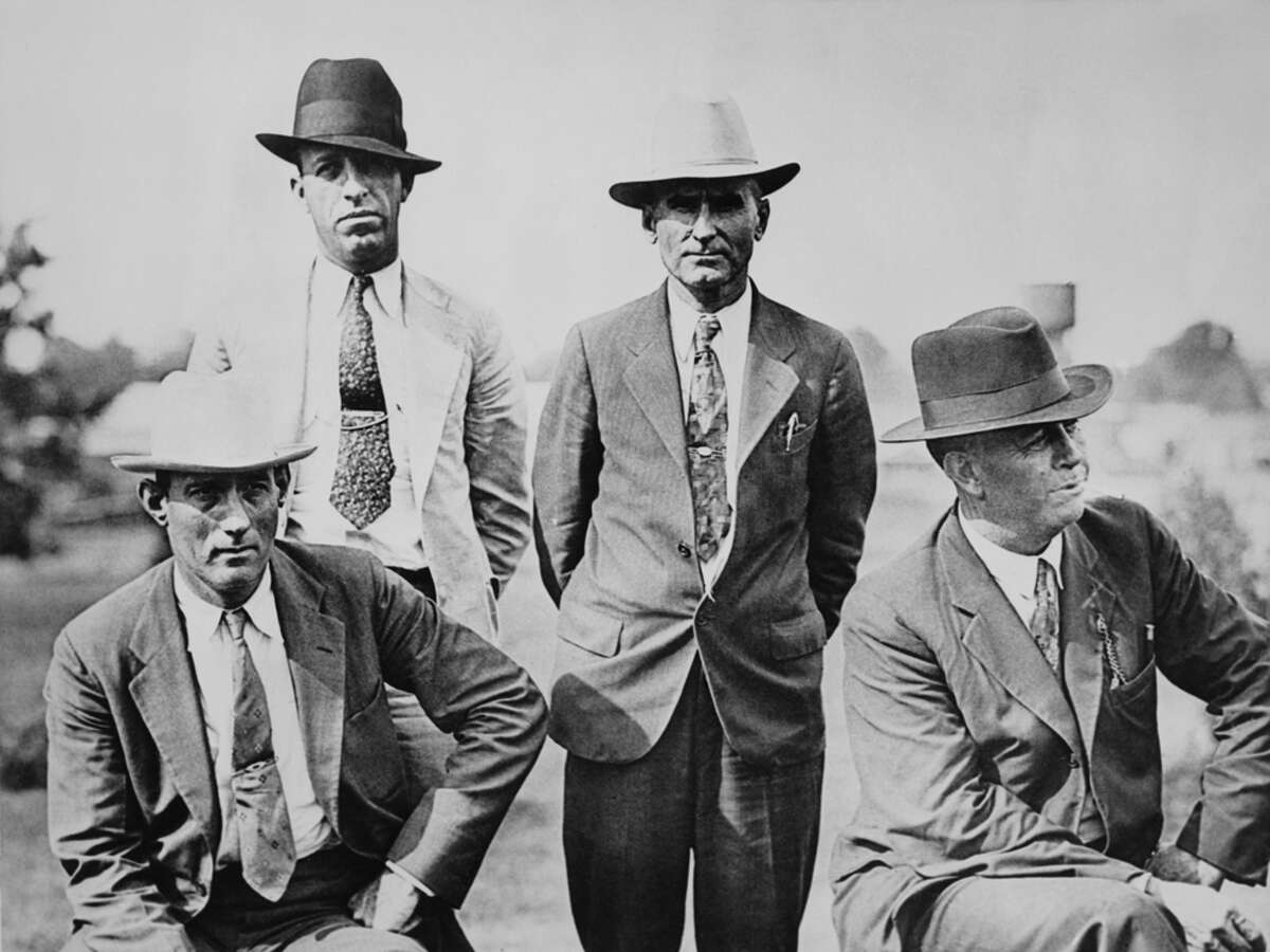 Four members of the six-man posse, who ambushed and killed fugitive criminals Clyde Barrow and Bonnie Parker near Gibsland, Louisiana on May 23, 1934. They are pictured on the day following the ambush. Left to right: Dallas County Sheriff's Deputies Bob Alcorn (1897 - 1964) and Ted Hinton (1904 - 1977) and former Texas Rangers B.M. 'Manny' Gault (1896 - 1947) and Captain Frank Hamer (1884 - 1955).