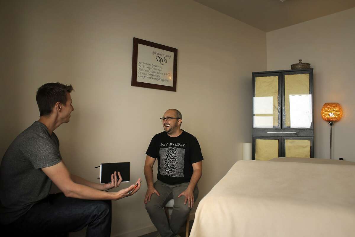Josh Danielson, left, creator of Loconomics, meets with Christopher Tellez, owner of the SF Reiki Center, about Tellez joining Loconomics in San Francisco, Calif., on Monday, May 19, 2014. Loconomics is a San Francisco tech startup that creates a marketplace for freelancers to sell their skills to others. It is organizing itself as a cooperative, in which all the freelancers on the platform will own shares, receive dividends and have a voice in running it.