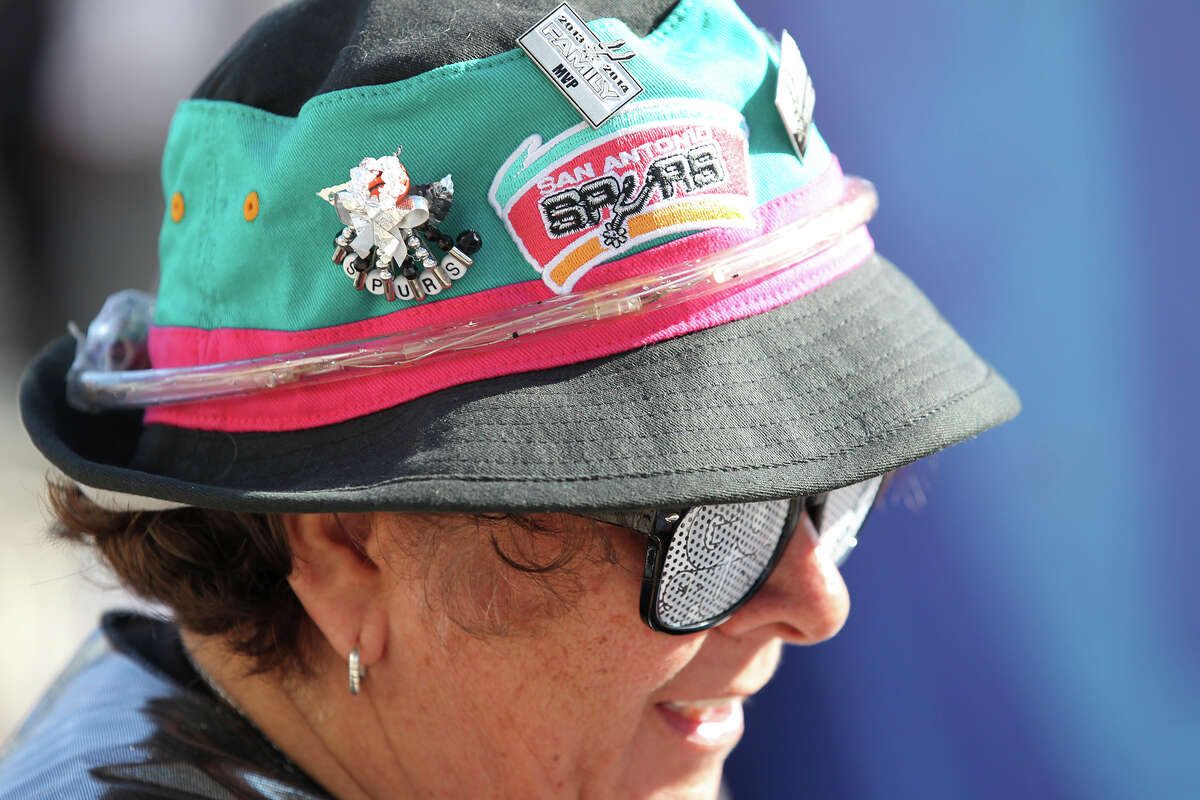 Martha Urias shows off retro colors and logo on her hat as Spurs fans start to party before the opener against the Thunder at the AT&T Center on May 19, 2014.