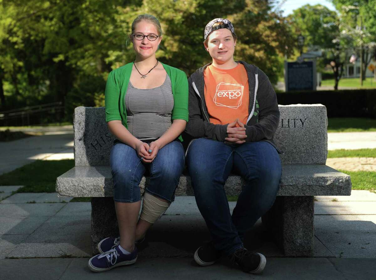 Newtown middle-schooler Tallie Nikitchyuk, left, and her sister, Ellie Nikitchyuk, a sophomore at Newtown High School, pose outside of Edmond Town Hall along Main Street in Newtown, Conn. Tuesday, May 20, 2014. The sisters are going to participate in a summit this weekend for the Junior Newtown Action Alliance, a gun violence-prevention group. Tallie and Ellie's younger brother, Bear Nikitchyuk, was in Sandy Hook Elementary School the day of the shooting, but was fortunate to escape unharmed.