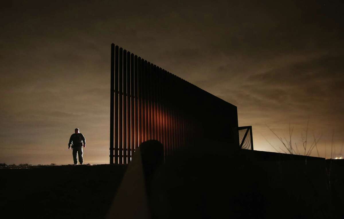 A Border Patrol agent stands near a section of border fence last year in La Joya. Lt. Gov. David Dewhurst wants a three-month border operation that would boost the number of troops, aircraft and boats to fight smuggling and drug cartel crimes.