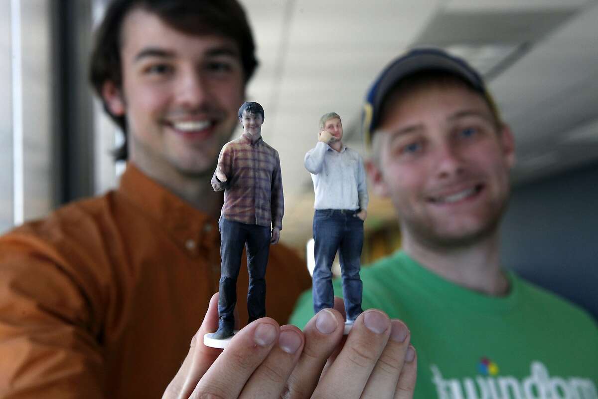 Co-founders David Pastewka, left, and Will Drevno hold 3D printed figurines of themselves as they stand for a portrait at Twindom's offices in Berkeley, CA, Wednesday May 21, 2014. Twindom creates 3D printed miniature figurines of real people using a rotating body scan capture system and 3D printers.