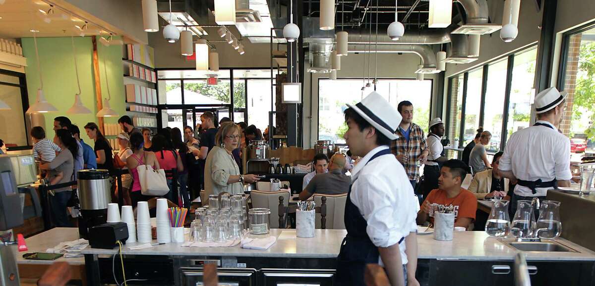 A crowd fills Common Bond Cafe & Bakery during a pre-opening lunch Friday, May 16, 2014, in Houston. ( James Nielsen / Houston Chronicle )