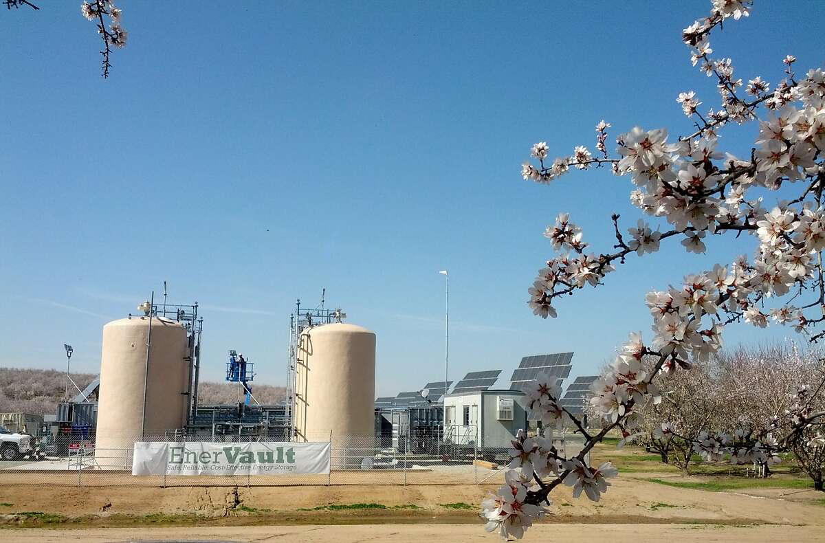 The EnerVault flow battery, with its two electrolyte tanks, will store electricity generated by this solar array in an almond orchard outside Turlock, CA.