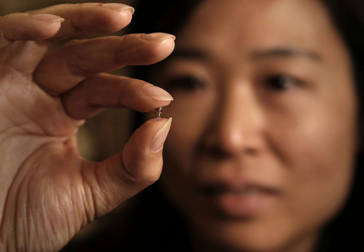 Professor Ada Poon holds the micro implant device at their research laboratory on the Stanford campus, in Palo Alto, Calif., on Wednesday May 21, 2014. Stanford electrical engineer, Professor Ada Poon, has invented a way to wirelessly transfer power deep inside the body, and then use this power to run tiny electronic medical gadgets such as pacemakers, nerve stimulators or new sensors/devices yet to be developed.