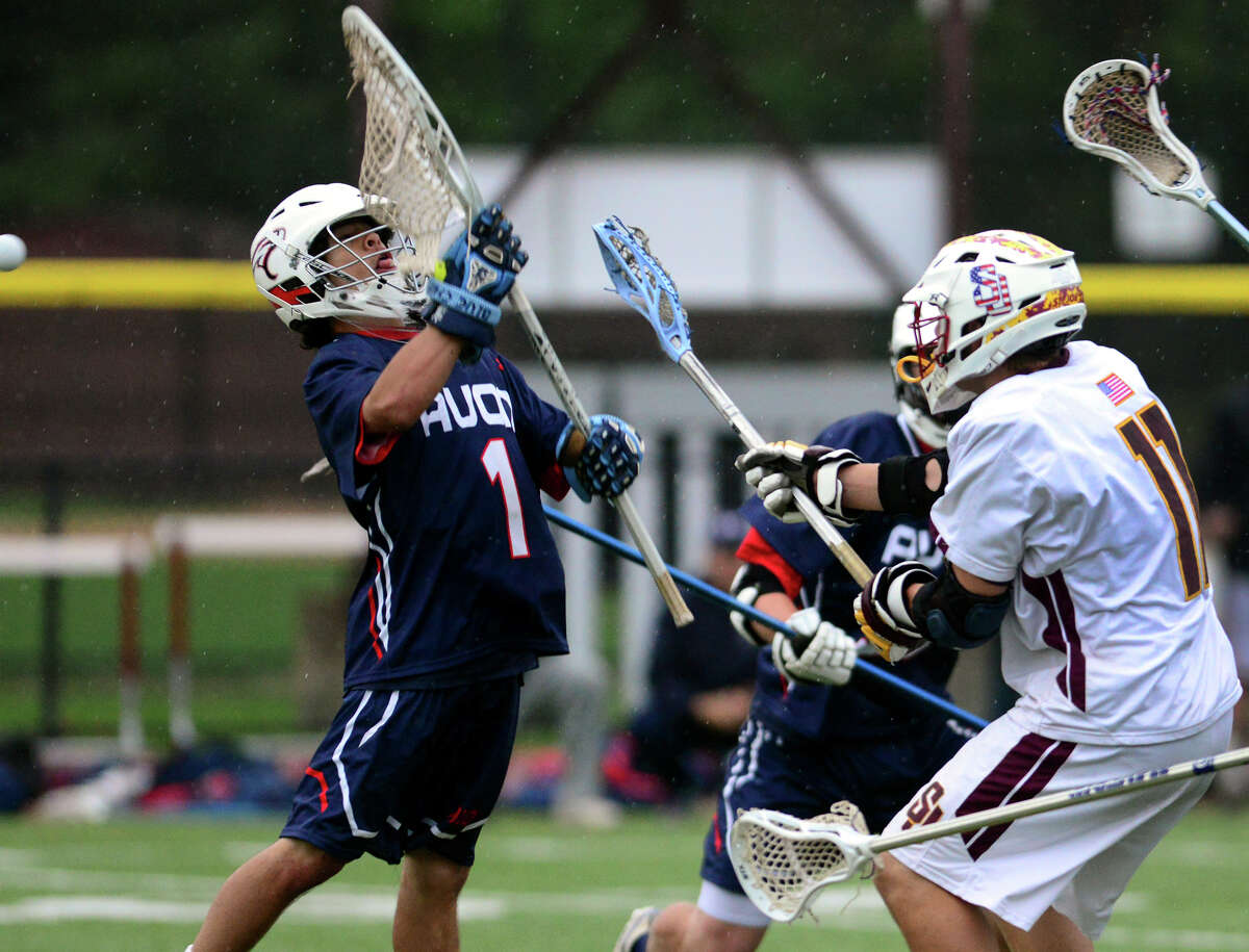 St. Joseph's Ryan Corcoran, right, gets the ball past Avon goalie Sean Glover, to score during boys lacrosse action in Trumbull, Conn. on Thursday May 22, 2014.