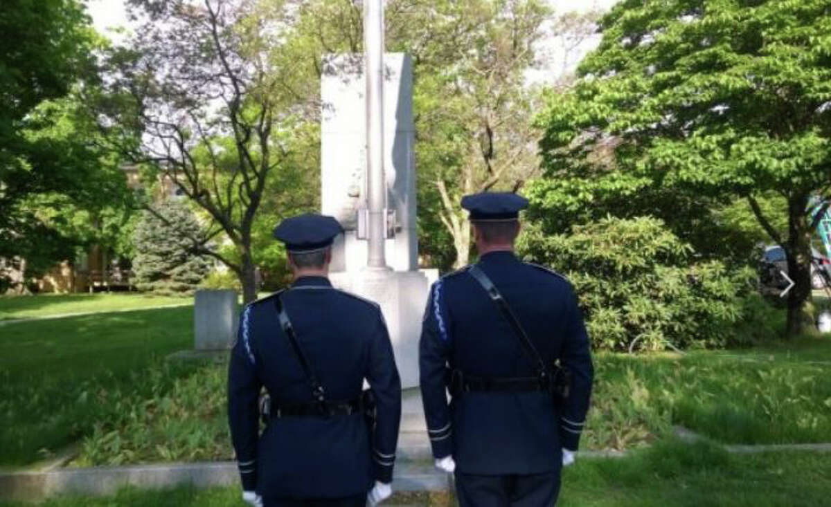 Th Greenwich Police Honor Guard stands watch for the cleaning of the memorial.