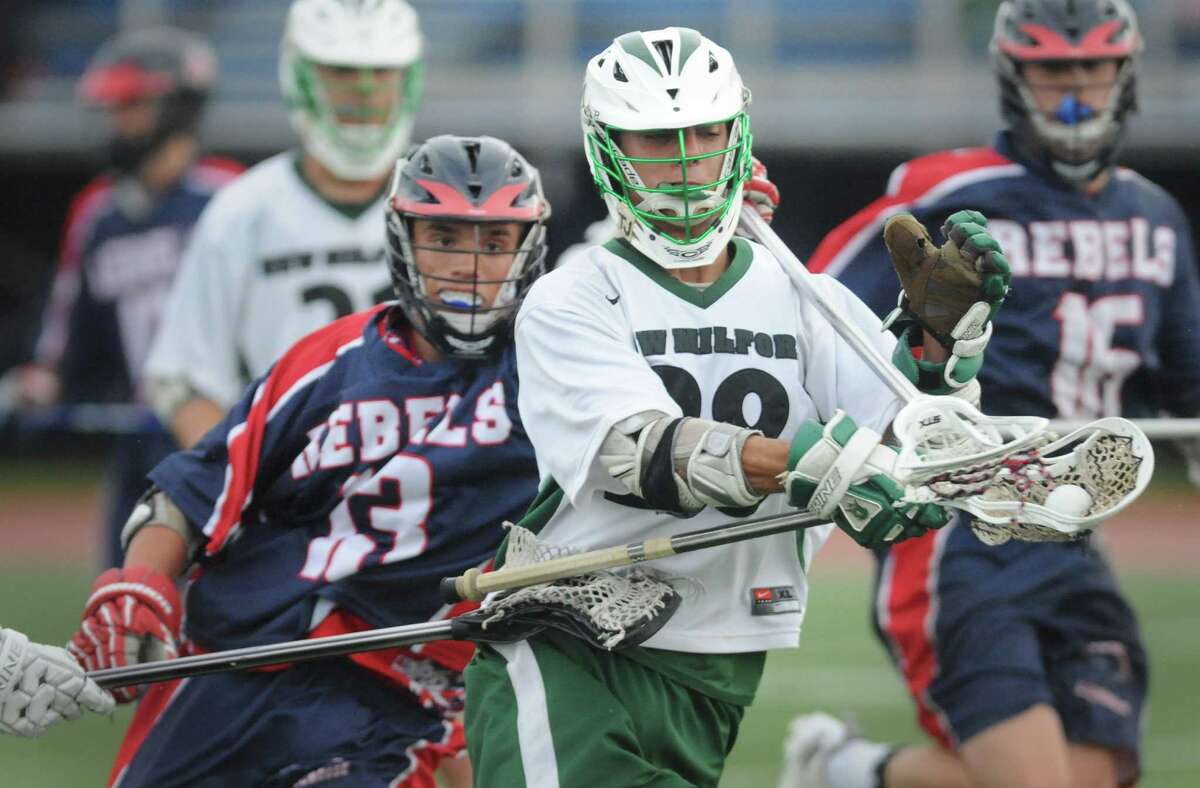New Fairfield's John Gephart (13) tries to steal the ball from New Milford's Jameson Steinhardt (28) in New Milford's 13-7 win over New Fairfield in the high school boys lacrosse game at Brookfield High School in Brookfield, Conn. Friday, May 23, 2014.