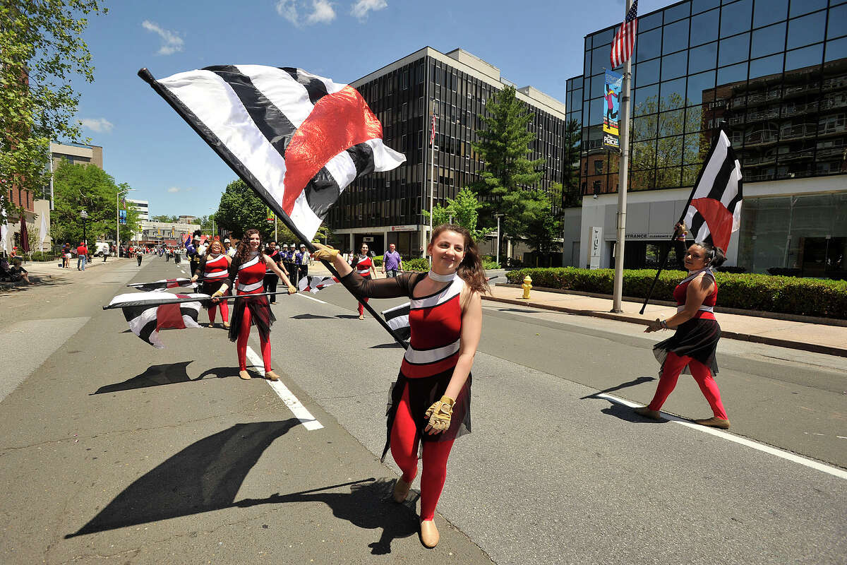 Whitney Cassell, with Westhill High School marching band flag corps, marches down Summer Street during the Memorial Day parade in downtown Stamford, Conn., on Sunday, May 25, 2014.