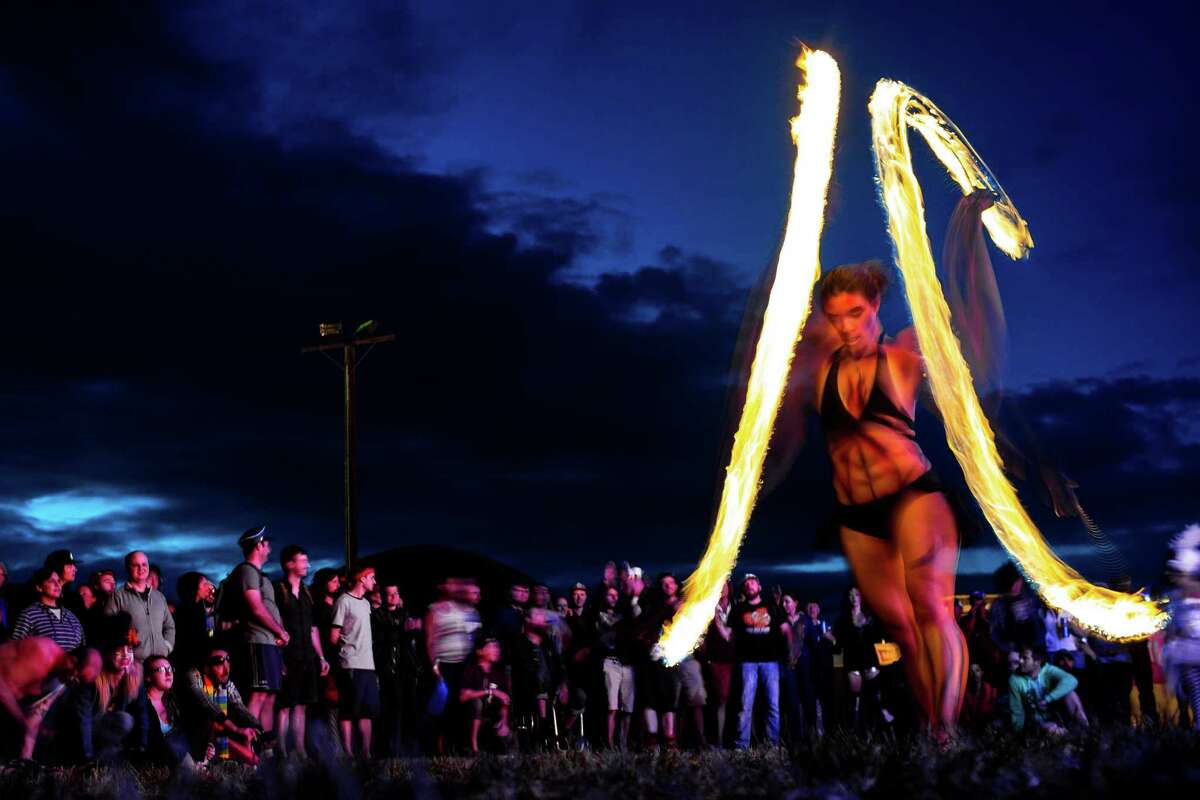 Firedancers from soul metal act, the Super Geek League, spin for an onlooking crowd on the third and final day of the annual Sasquatch music festival Sunday, May 25, 2014, in George, Wash.