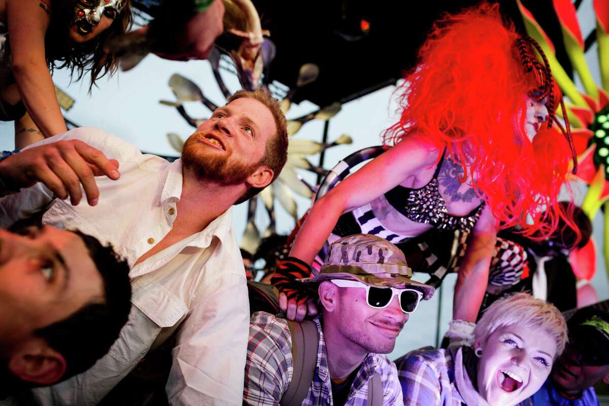 Super Geek League dancers hold down fans to the stage on the third and final day of the annual Sasquatch music festival Sunday, May 25, 2014, in George, Wash.