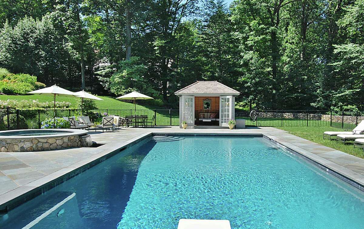 The saltwater pool behind the house at 1599 Fence Row Drive in Fairfield also features a spa, seen at left, and cabana.