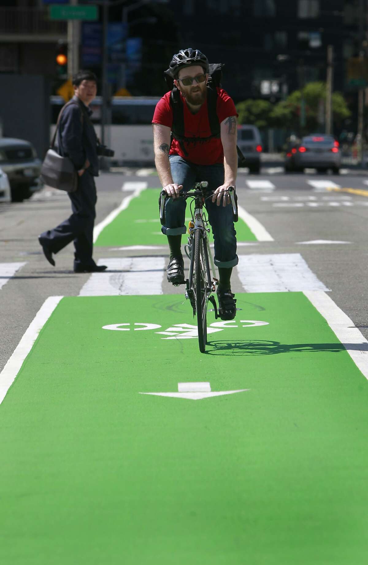 Jared Shoupe rides his bicycle on the new Polk Street bicycle lane past City Hall in San Francisco, Calif. on Saturday, May 24, 2014.