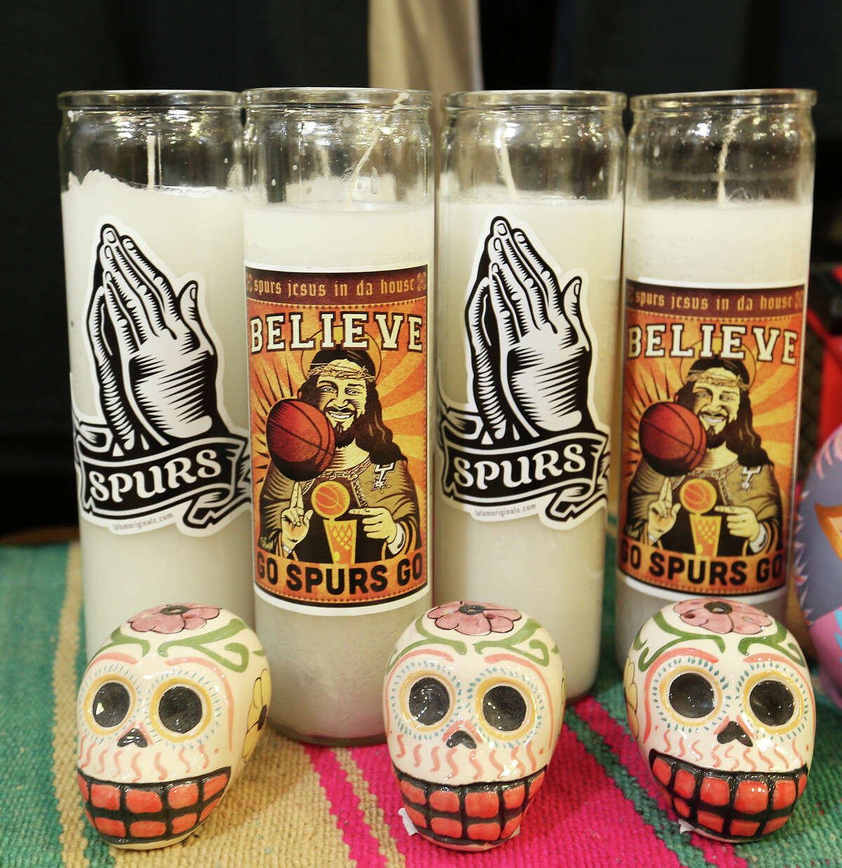"Spurs Jesus" merchandise is for sale at Melissa Guerra in the Pearl Brewery complex, Monday, May 26, 2014. The candles and t-shirts were designed through a collaboration between Spurs Jesus and artist Robert Tatum. The proceeds from the sales will be donated to elementary school teachers for art supplies.