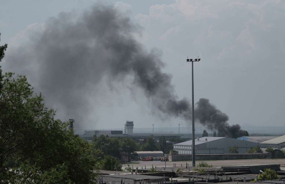 Smoke rises at the airport outside Donetsk, Ukraine, after armed separatists descended on the area Monday. President-elect Petro Poroshenko ruled out negotiating with the rebels.