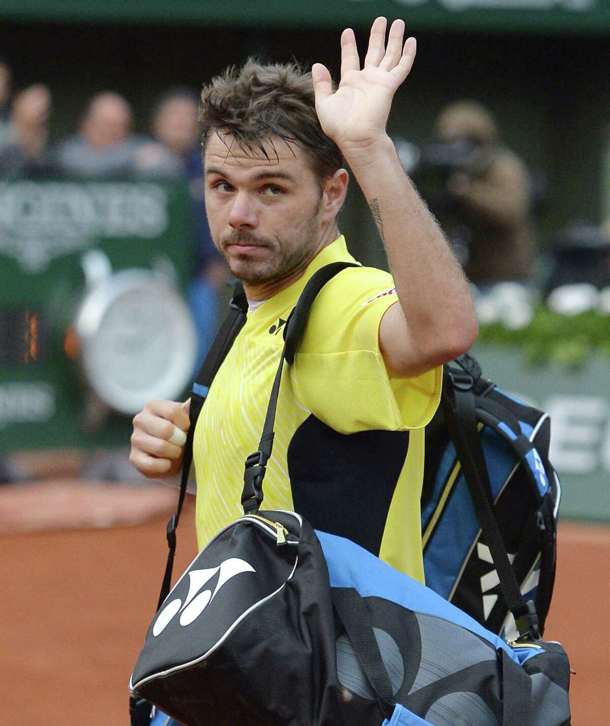 No. 3 Stan Wawrinka bids adieu to the Roland Garros crowd after losing to Guillermo Garcia-Lopez in the first round.