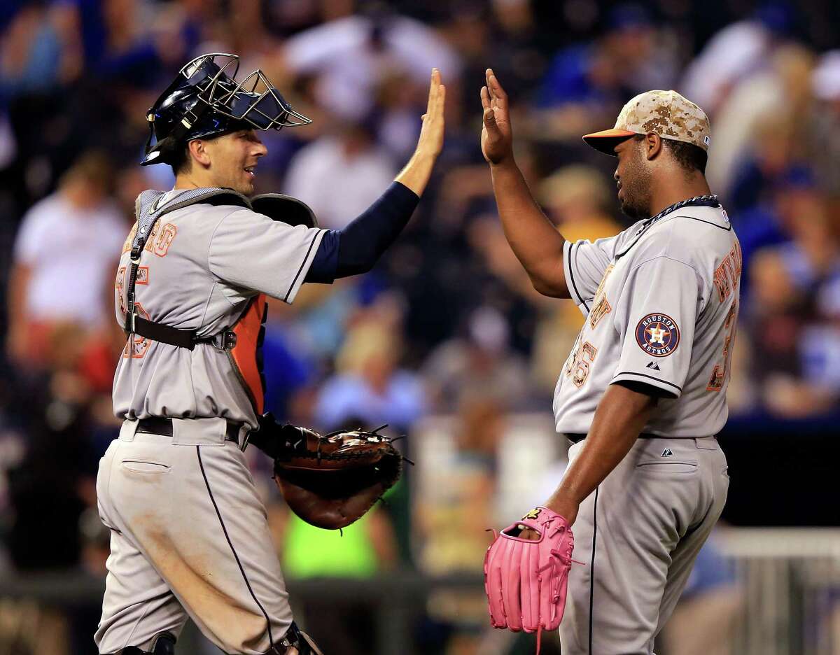 Reliever Jerome Williams, right, earns a high-five from catcher Jason Castro after recording the final out in the Astros' 9-2 victory over the Royals on Monday night. It was the team's third consecutive win.