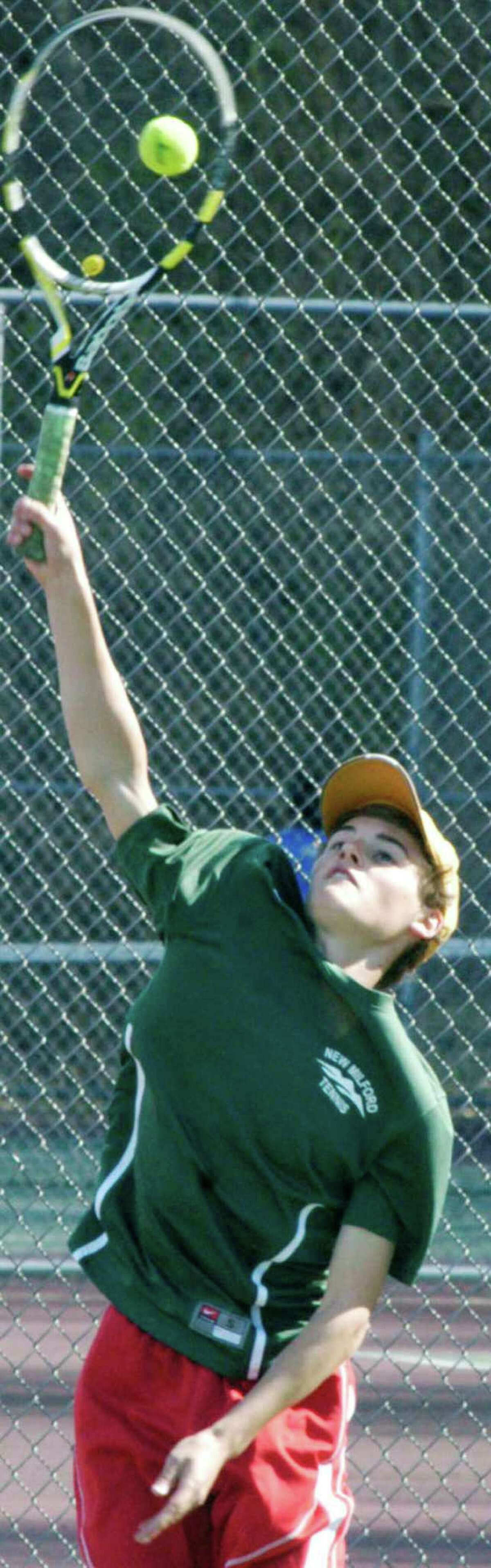 Green Wave sophomore Hunter Berrett finds the sweet spot on the racquet with this serve during a recent New Milford High School boys' tennis match. May 2014