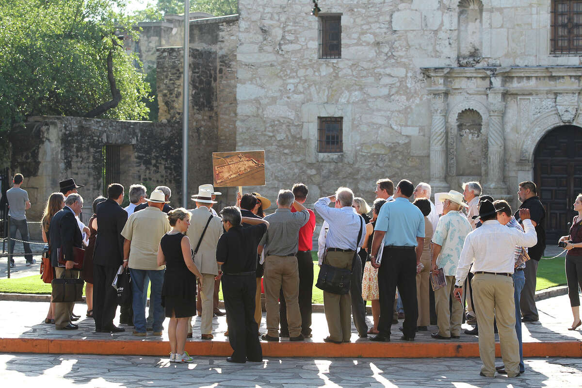A drawing of the original Alamo compound boundaries is used as the city's Alamo Plaza Commission tours the site on May 28, 2014.